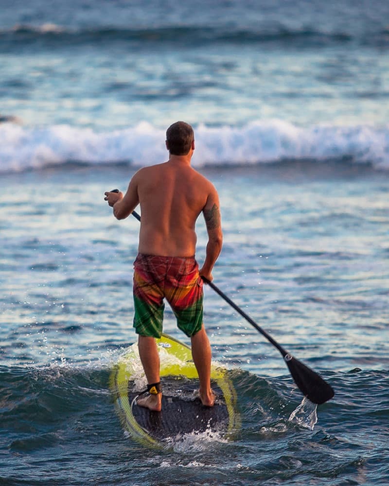 Stand-up paddleboarding on calm ocean water