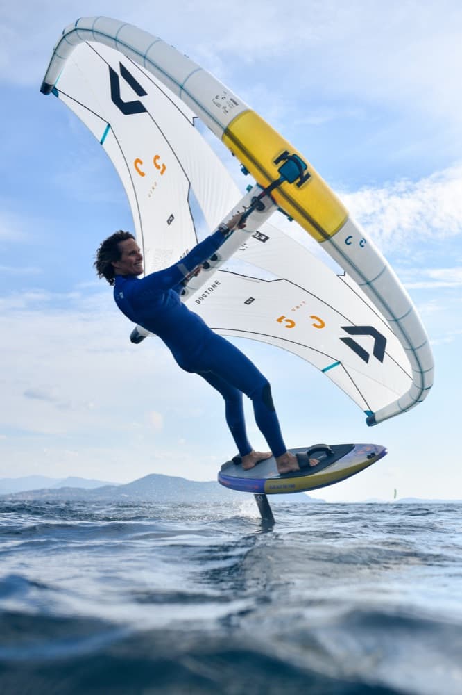 Wingfoiler riding above the water